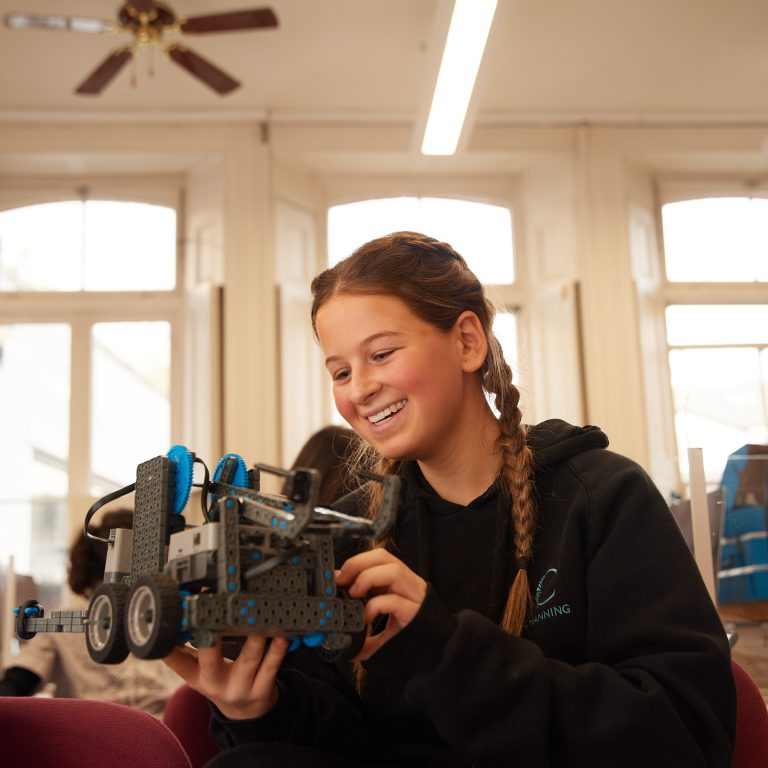 girl holding a robot