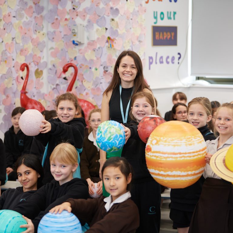 students holding planets