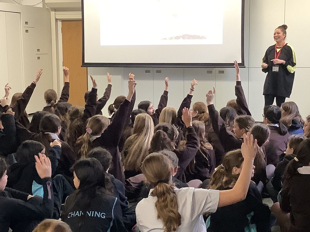students raising their hands