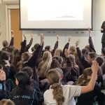 students raising their hands
