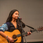 Student playing the guitar