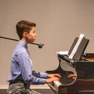 Student singing whilst playing the piano