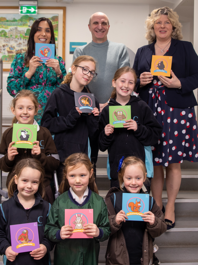 teachers and students holding up books