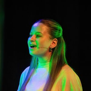 student on stage for wicked